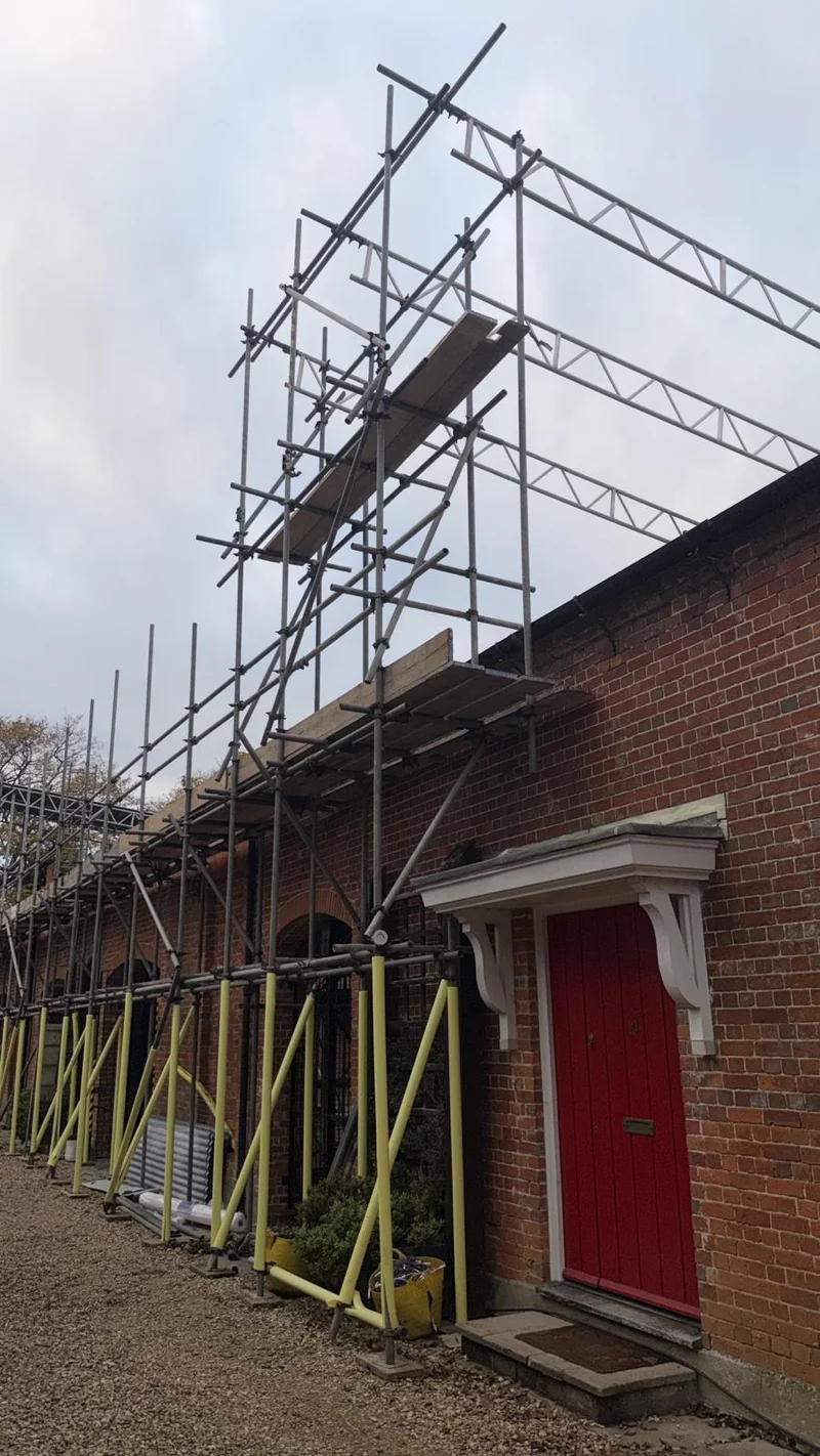Scaffolding along a brick building by A&S Scaffolding